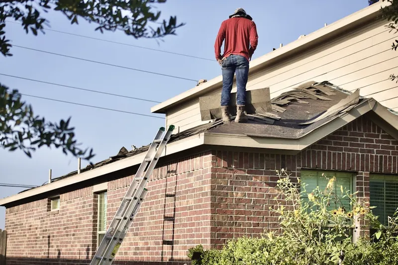 Professional roofer working on a residential roof in Wolfes Overlook